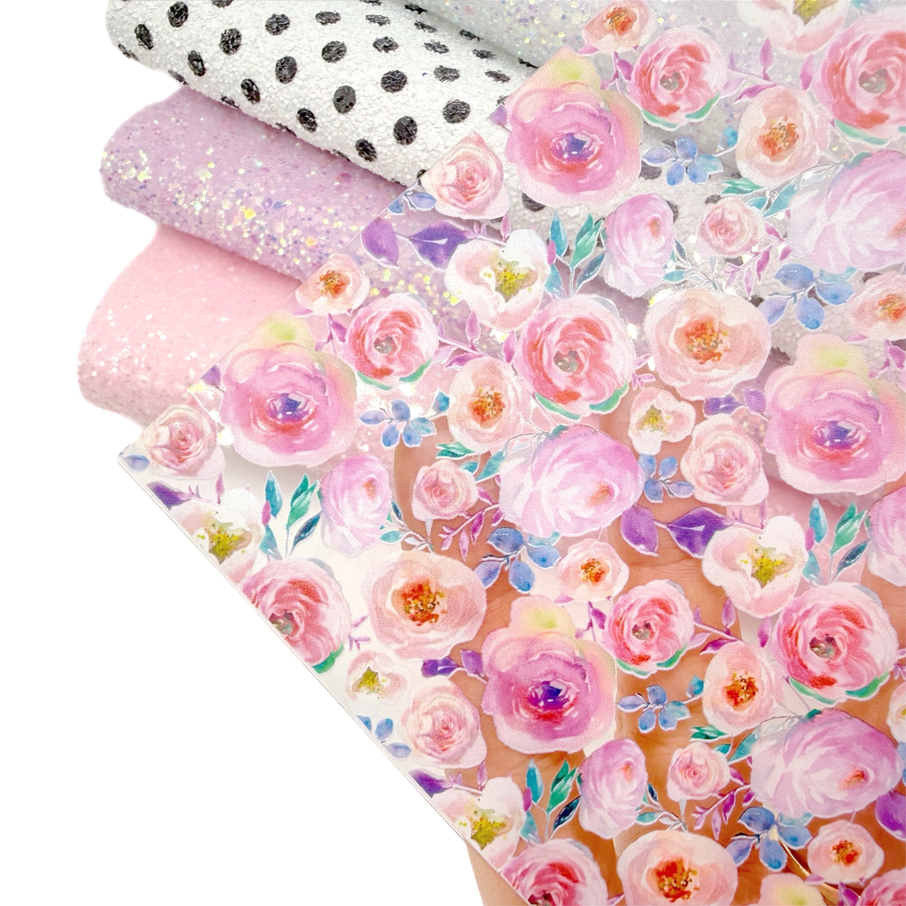 Rolls of floral and polka dot patterned transparent fabrics and glitter fabrics